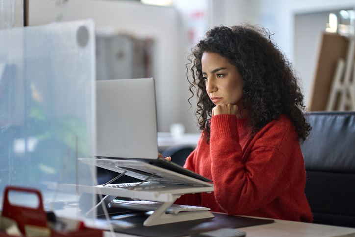 A woman determining how the employee stock purchase plan tax works. 